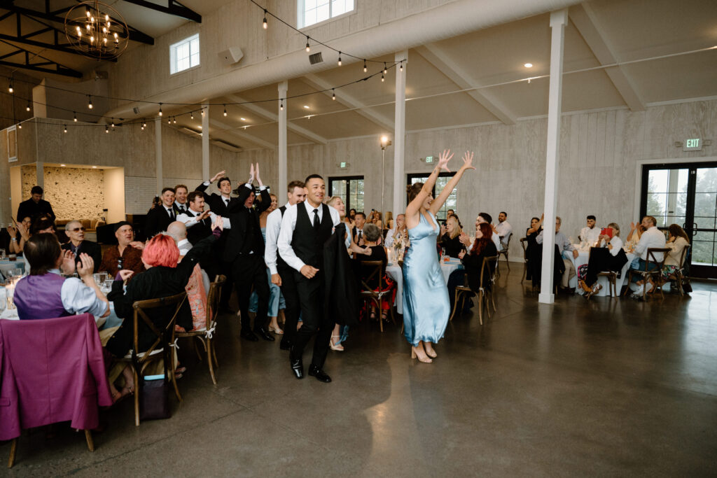 Wedding party walking into reception on wedding day at Woodlands