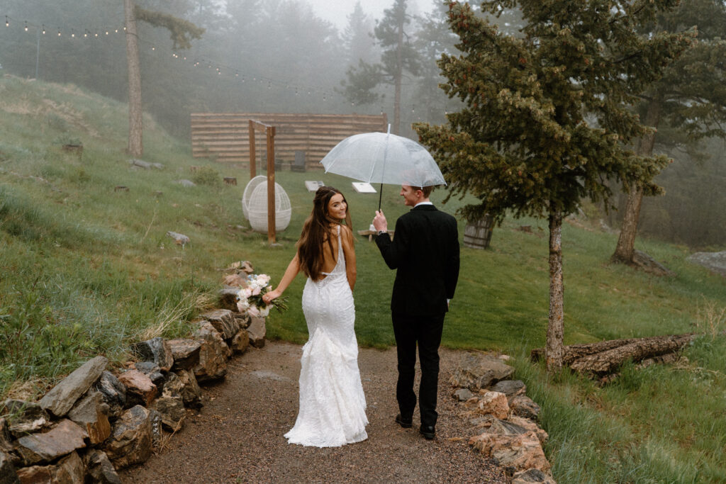 bride and groom walking in the rain on wedding day at Woodlands