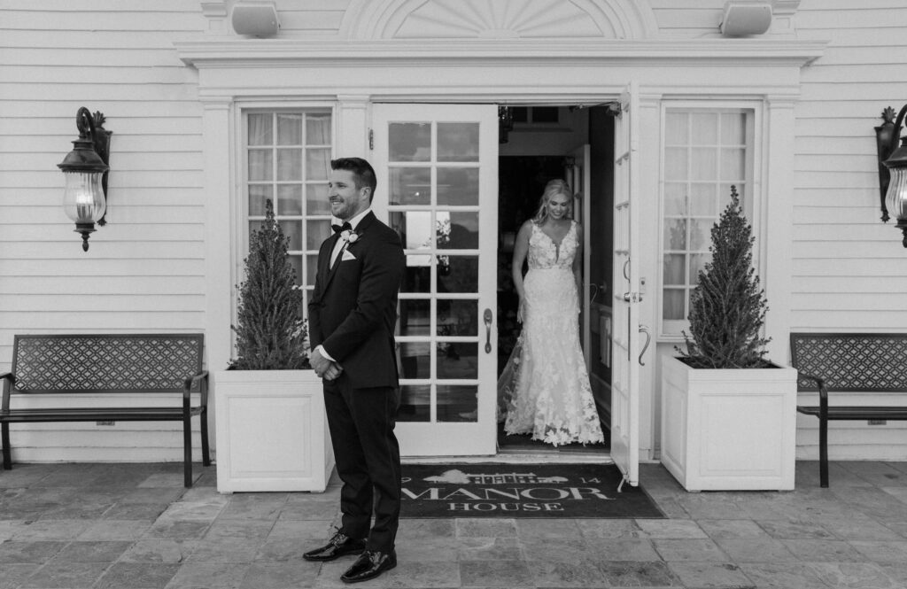 Groom waiting for bride during first look on wedding day at The Manor House