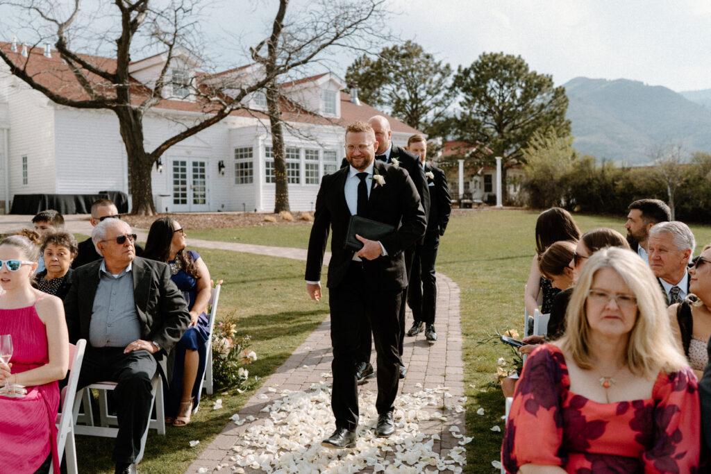 Officiant walking down the aisle on wedding day at The Manor House