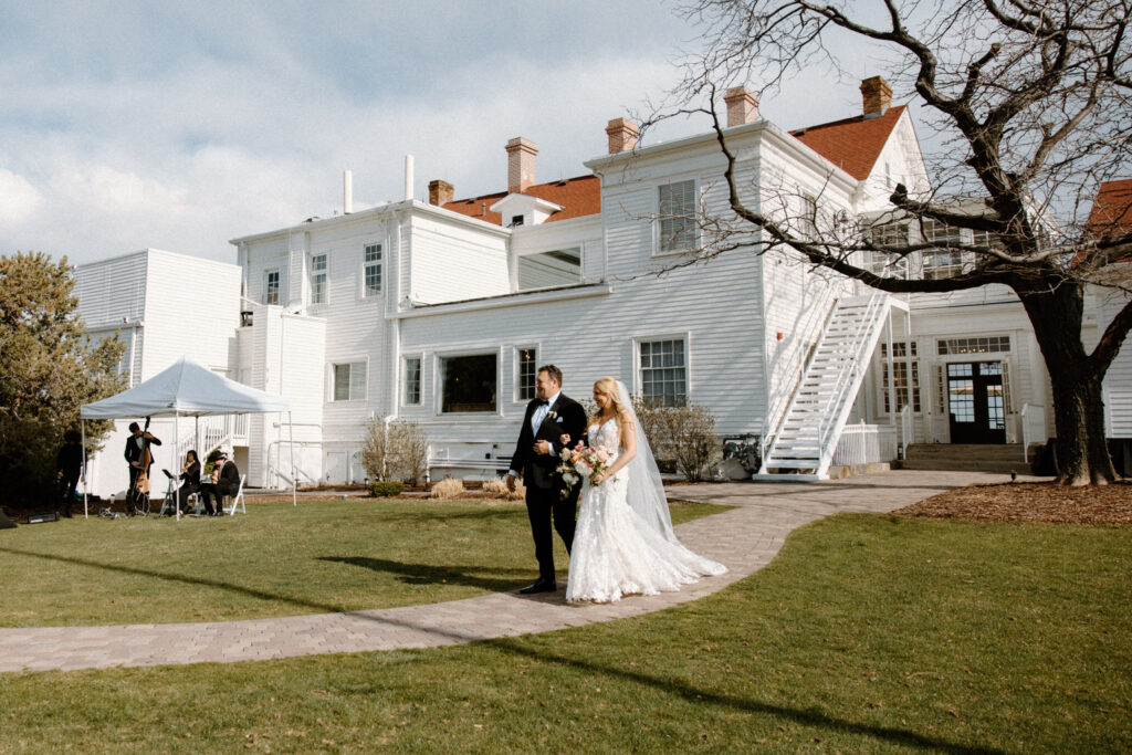 Bride walking down the aisle on wedding day at The Manor House