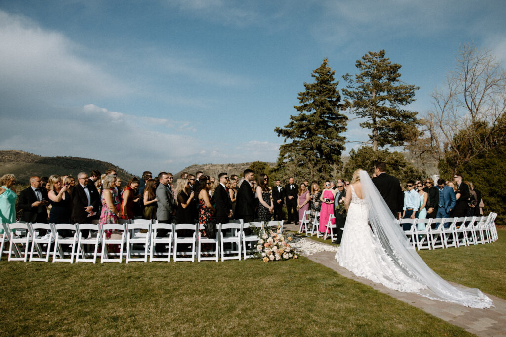 Bride and dad walking down the aisle on wedding day at The Manor House