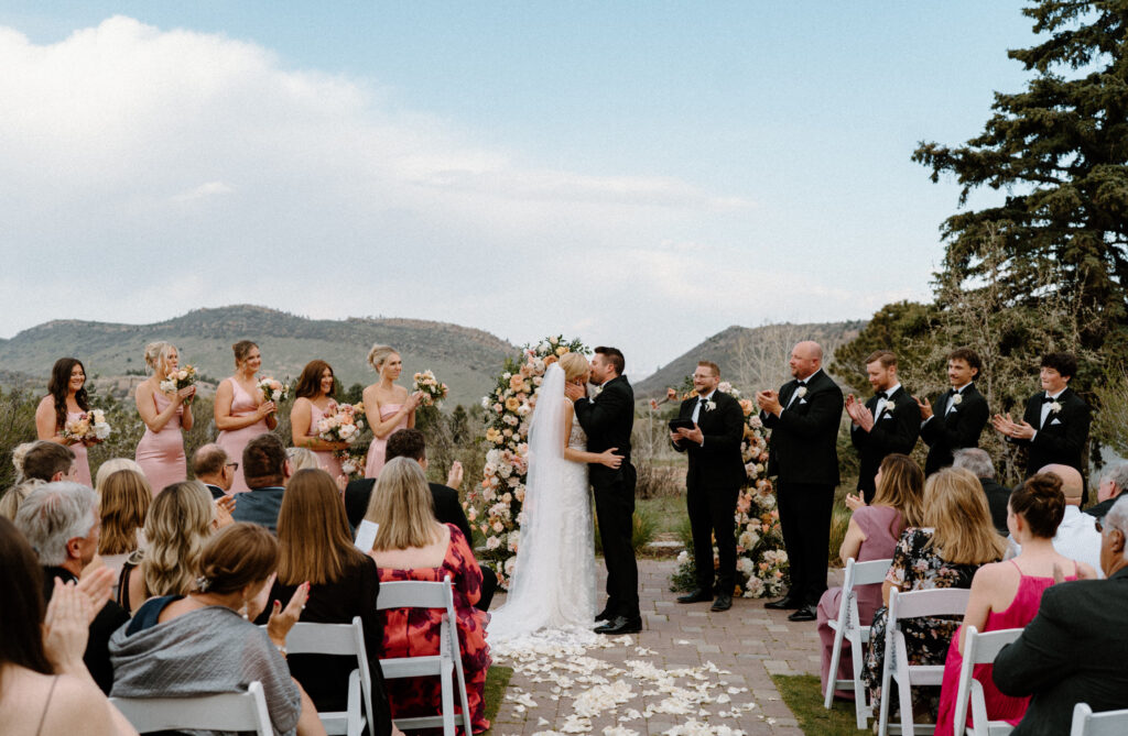 Bride and groom kissing during ceremony at The Manor House