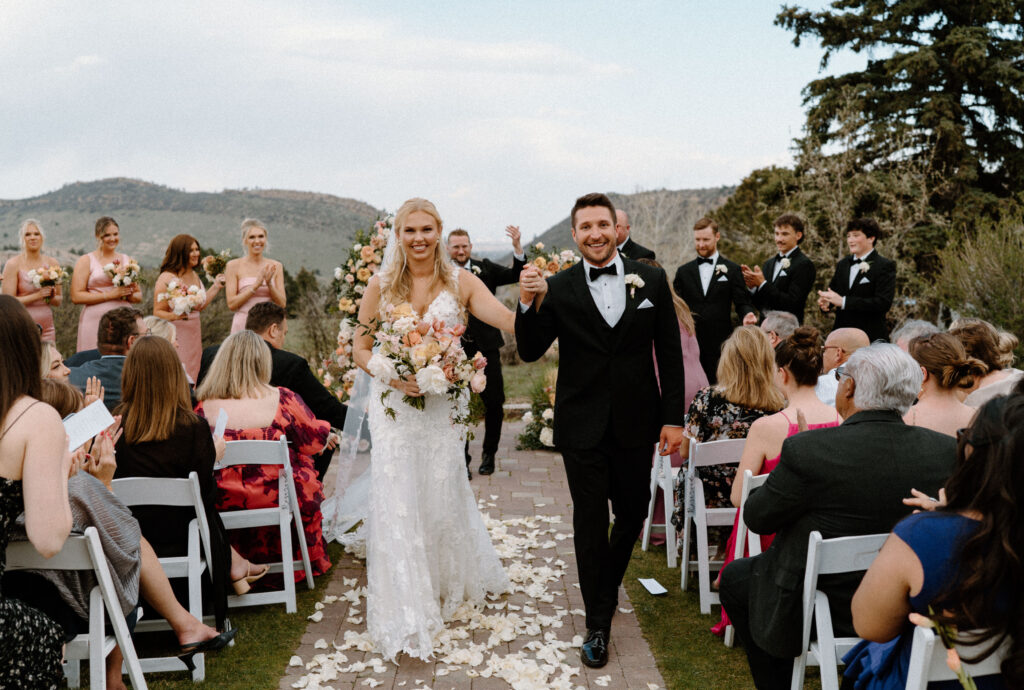 Bride and groom walking down the aisle after ceremony at The Manor House