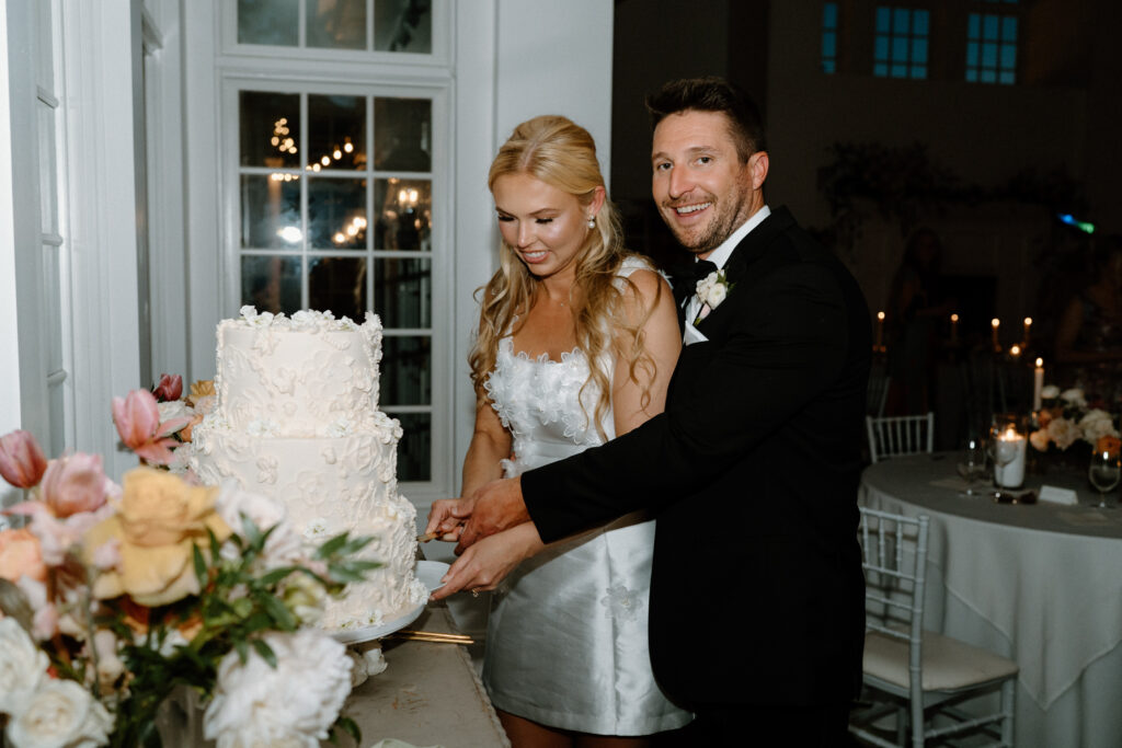 Bride and groom cutting their cake on wedding day at Manor House
